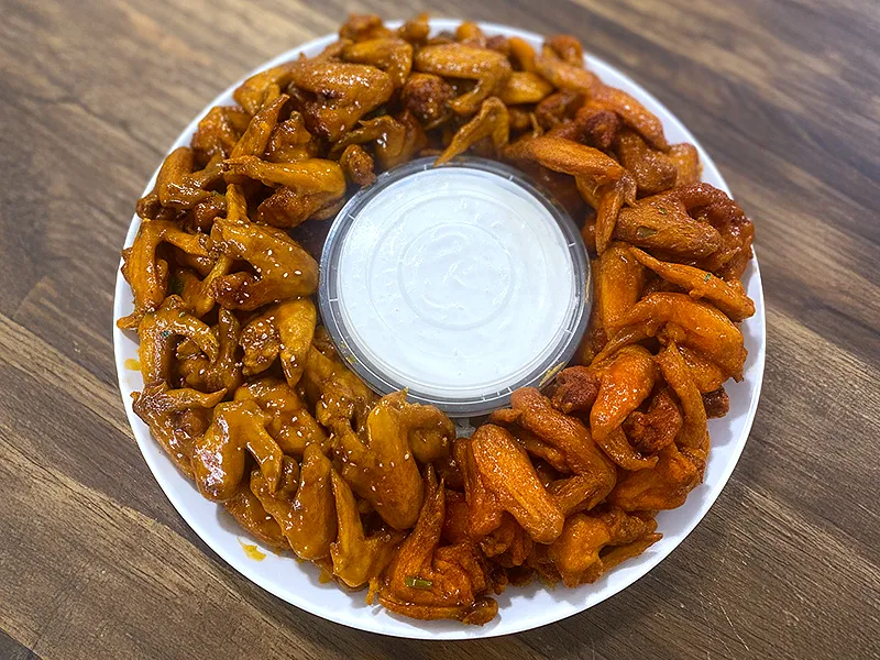 Platter of party wings, two flavors, with ranch in the center